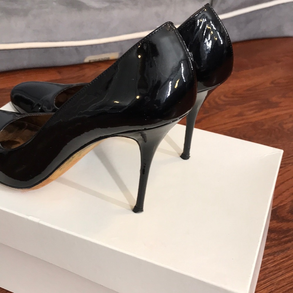 Black patent leather pumps with spike heels